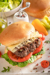 Hot roasted cheeseburger made of meat and vegetables.