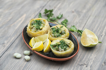 Traditional delicious Turkish food; Artichoke with olive oil (zeytinyagli enginar), artichoke topped with green beans and veggies with lemon slice 
