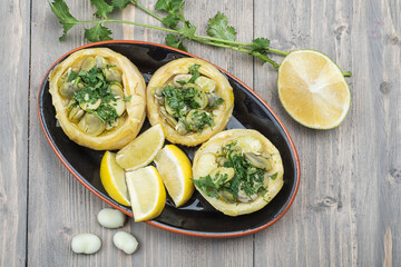 Traditional delicious Turkish food; Artichoke with olive oil (zeytinyagli enginar), artichoke topped with green beans and veggies with lemon slice 
