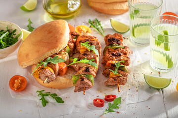 Tasty grilled shashlik with bun baked on a grilled.