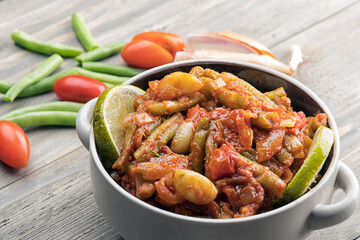 Arabic Cuisine; Egyptian traditional green bean stew. A delicious vegan meal with fresh green beans doused in aromatic tomato sauce.