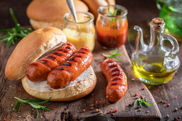 Fat bun with roasted sausage made on bonfire grill.