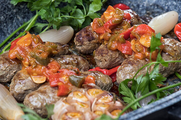 Kofta with tomato sauce, Cooked tomato and cooked potato garnished with pine seeds and mint isolated on white background 