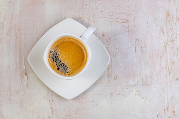 Obraz na płótnie Canvas White cup of espresso on a light rustic background.