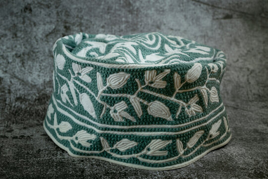 A traditional Omani cap in beautiful colors called kumma , which is part of the Omani traditional costume