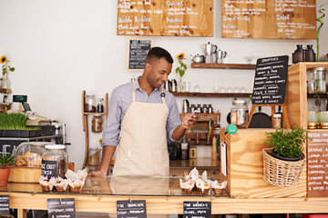 Black man, coffee shop and store phone of an entrepreneur with happiness from small business. Cafe,...