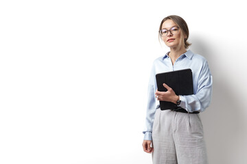 Young caucasian woman wearing eyeglasses, holding digital tablet, standing over white background