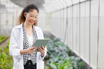 Happy Smiling Scientist Modern Farmer using Tablet Monitor Agriculture Farm Plant Research Working.