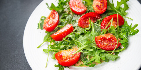 plate of salad tomato, arugula, grated cheese, olive oil healthy meal food snack on the table copy space food background rustic top view keto or paleo diet veggie vegan or vegetarian food no meal 