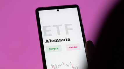 A Spanish investor analyzing an etf fund. ETF text in Spanish : Germany, buy, sell.