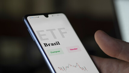 An investor analyzing an etf fund. ETF text in Spanish : Brazil, buy, sell.