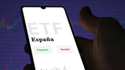 An investor analyzing an etf fund. ETF text in Spanish : Spain, buy, sell.