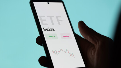 An investor analyzing an etf fund. ETF text in Spanish : Switzerland, buy, sell.