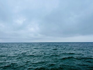 Cloudy gray seascape, sea coast, windy cloudy weather 