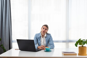 Fototapeta na wymiar Thoughtful anxious business woman looking away thinking solving problem at work, worried serious young woman concerned make difficult decision lost in thought reflecting sit with laptop