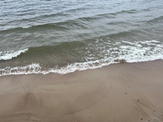 Fototapeta na wymiar Transparent sea water, sea water ripples, sandy coast