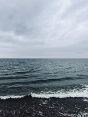 Cloudy gray seascape, sea coast, windy cloudy weather 