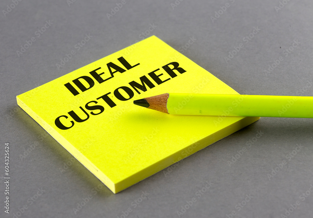 Poster ideal customer text written on a sticky on grey background