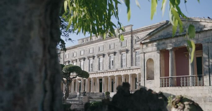 Cinematic dolly shot of Facade with colonnade of the museum of asiatic art in Esplanada Square at Corfu island, an old royal palace st. michael and st. george in Corfu town, Greece