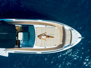 aerial view Young woman on a yacht in the amalfi coast, positano, italy - 604344234
