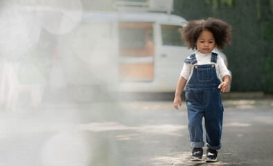 Smiling multiracial child happy walking outdoors. Portrait of cheerful multiethnic daughter enjoying carefree leisure in backyard. Cheerful kid childhood walk in park freedom expression. copy space.