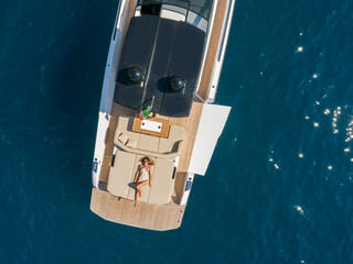 aerial view Young woman on a yacht in the amalfi coast, positano, italy - 604344672