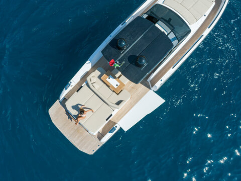 aerial view Young woman on a yacht in the amalfi coast, positano, italy