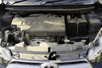 under the car hood is a very dirty engine. automobile maintenance and service concept.