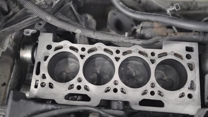 Working cycle of open block of four cylinder petrol engine in repair mechanic shop