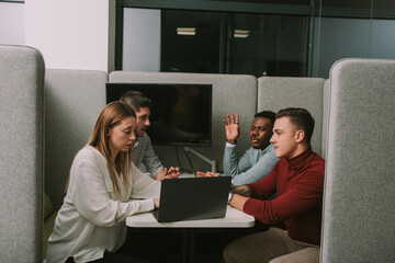 Young multiracial group of creative people discussing new marketing ideas at modern co working space