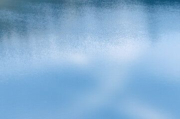 Water surface. Blue water background with soft waves. Texture of the water surface.