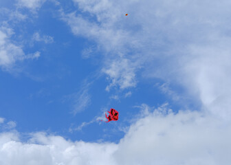 Naklejka na ściany i meble kite in the sky, red kite, cloudy blue sky, red kite in the blue sky