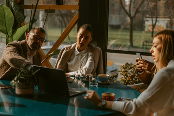 Group of business people looking at the laptop