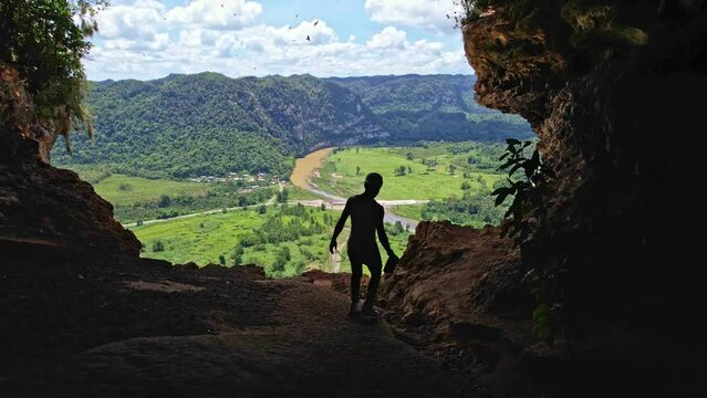 hiker overlooking natural window cave cueva ventana in arecibo puerto rico