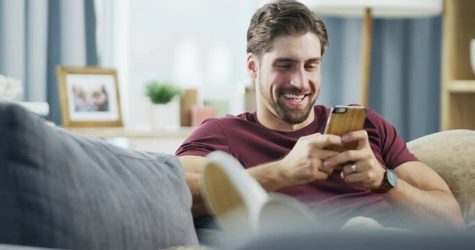 Smile, relax and a man with a phone on the sofa for social media, communication and online chat. Happy, house and a person typing on a mobile app for conversation, reading notification and email