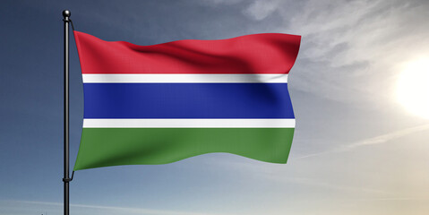 The Gambia national flag cloth fabric waving on beautiful grey sky Background.