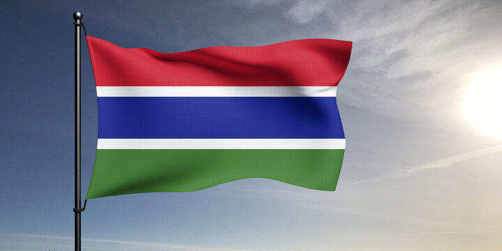 The Gambia national flag cloth fabric waving on beautiful grey sky Background.
