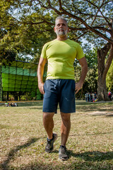 50 year old man jogging in the park on a beautiful sunny day