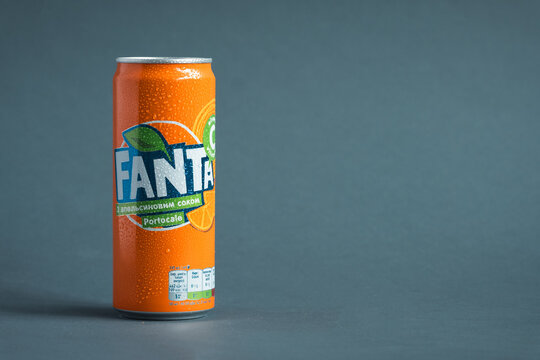 KYIV, UKRAINE - May 09: Close up shot of classic Fanta orange can on the grey background. Popular product of The Coca-Cola company. Cold drink concept