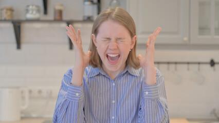 Portrait of Tense Young Woman Screaming in Pain