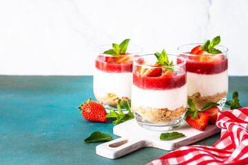 Cheesecake in a glass. Strawberry cheesecake, delicious dessert no baking in jars.