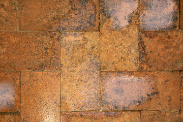 The surface is made of brick blocks in orange color. 
Brickwork for the floor after the rain. Copy...