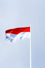 flag of Indonesia, flag of the country, waving flag, red and white flag, waving flag against a clear sky background