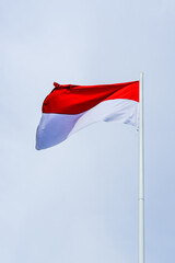 flag of Indonesia, flag of the country, waving flag, red and white flag, waving flag against a clear sky background