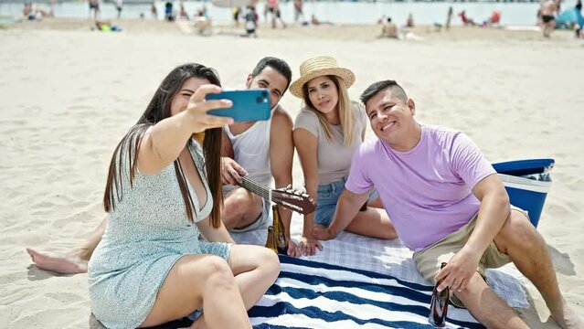Group of people make selfie by smartphone having party at beach