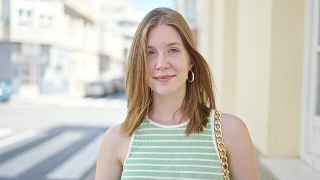 Young blonde woman smiling confident taking out glasses at street