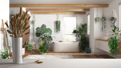 Fototapeta na wymiar White table top or shelf with straws, dry plants, ornament, ears, sheaf, branch in vase, over bathroom with bathtub and many houseplants, architect interior design, urban jungle