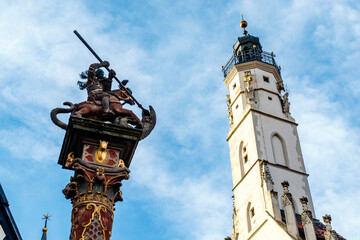 Fototapeta na wymiar Town hall tower and statue of Saint George and the dragon in Rothenburg ob der Tauber, Germany, Europe