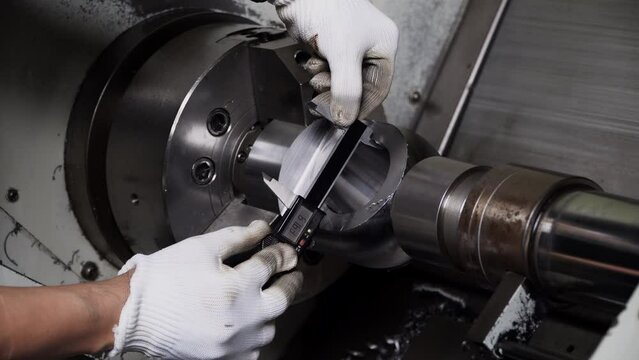Quality control manufacturing.Hands of an engineer measures a metal part with a digital vernier caliper