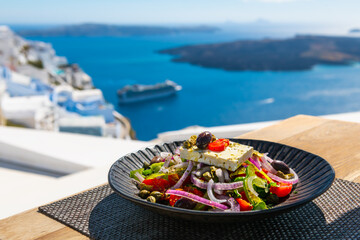 Greek salad with beautiful sea view in Santorini island, Greece.
